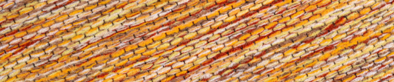 A close up image of a yellow and orange yarn.